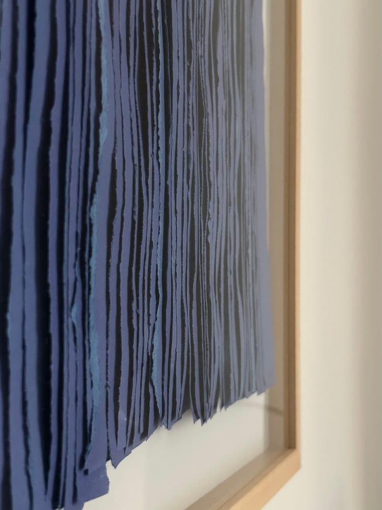 Detail: the torn edges of the paper strips