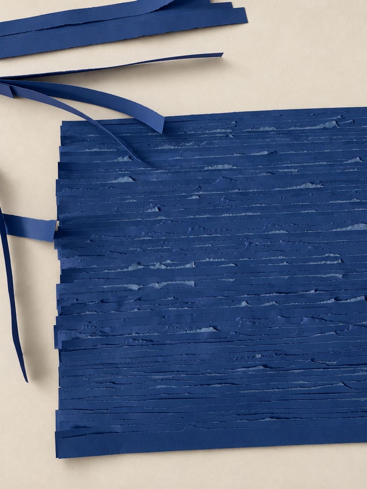 Process: torn blue paper strips